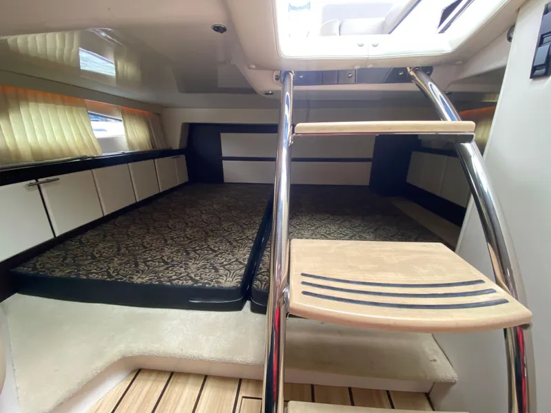 Slide: The Image of Interior cabin of 2015 Regal 32 Express boat with stairs and bed. - 29