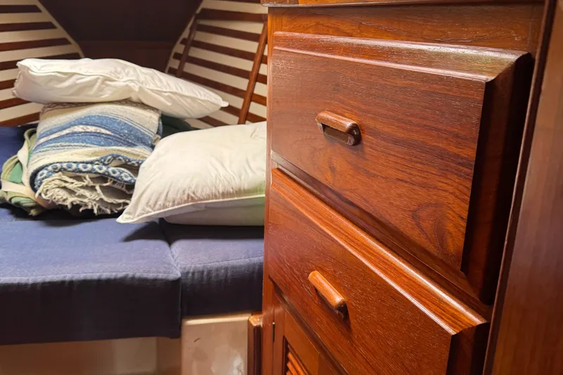 Slide: The Image of Interior of a 1984 Endeavour 33 with wooden furniture and bed. - 11