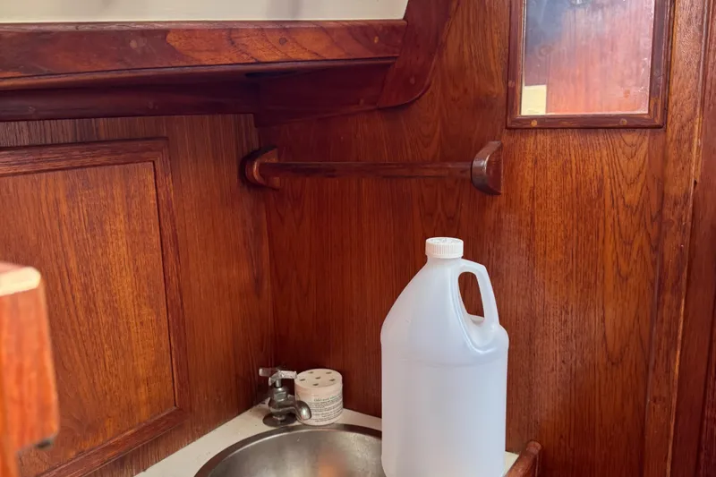 Slide: The Image of Interior of a 1984 Endeavour 33 yacht with sink and wood paneling. - 14