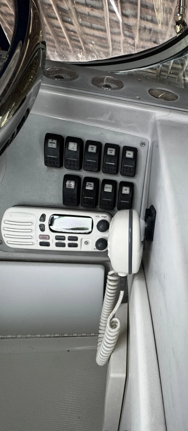 Slide: The Image of Control panel of a 2001 Formula 40 PC boat with switches and a radio handset. - 36