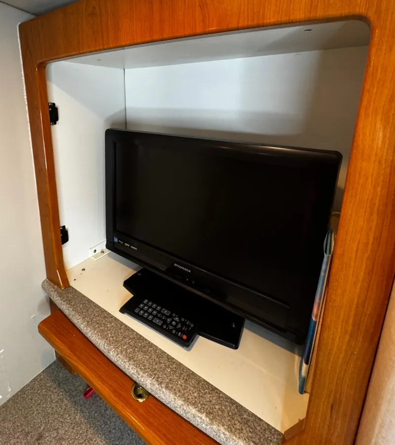 Slide: The Image of 2001 Formula 40 PC interior with TV and remote in wooden cabinet. - 47