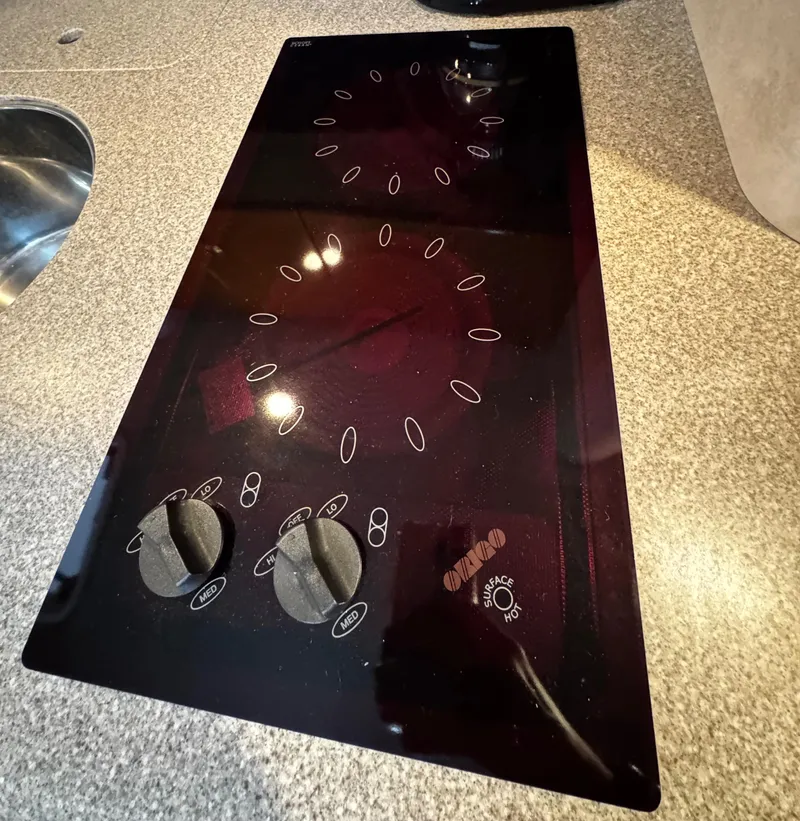 Slide: The Image of 2001 Formula 40 PC stovetop with dual burners on a granite countertop. - 48