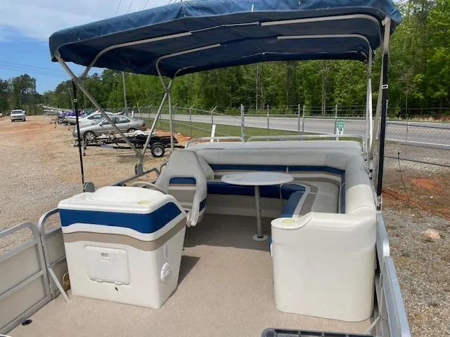 Slide: The Image of 1999 Sylvan 20 Elite pontoon boat with canopy and seating area. - 10