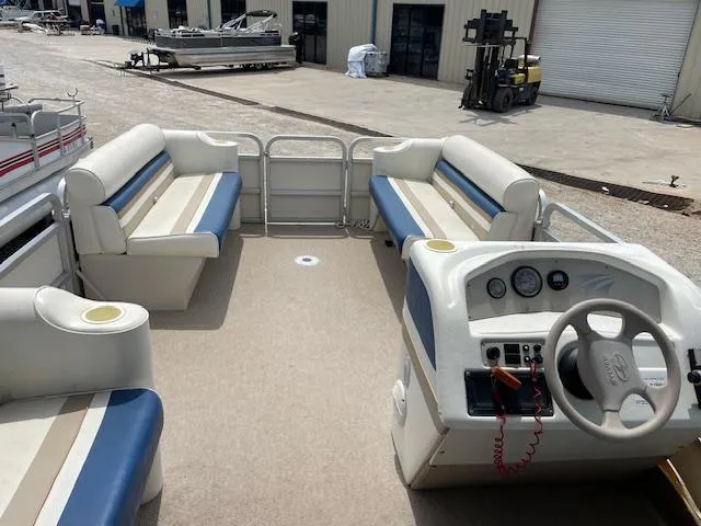 Slide: The Image of 1999 Sylvan 20 Elite pontoon boat interior with seating and steering console. - 12