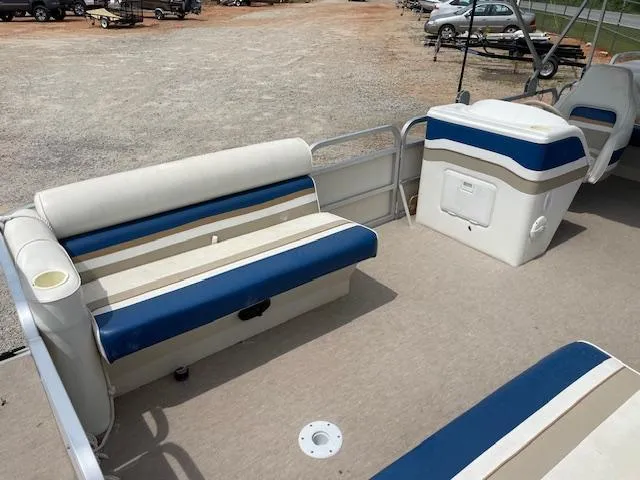 Slide: The Image of 1999 Sylvan 20 Elite pontoon boat interior with blue and white seating. - 9