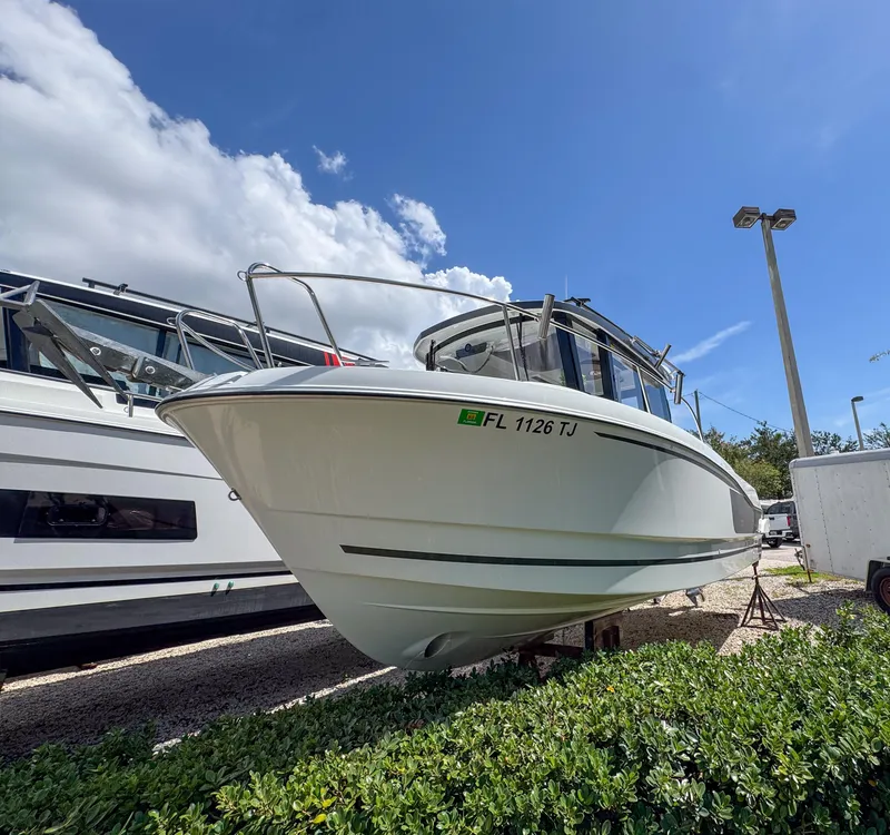 Slide: The Image of 2022 Jeanneau NC795 Sport boat on display under a clear blue sky. - 1