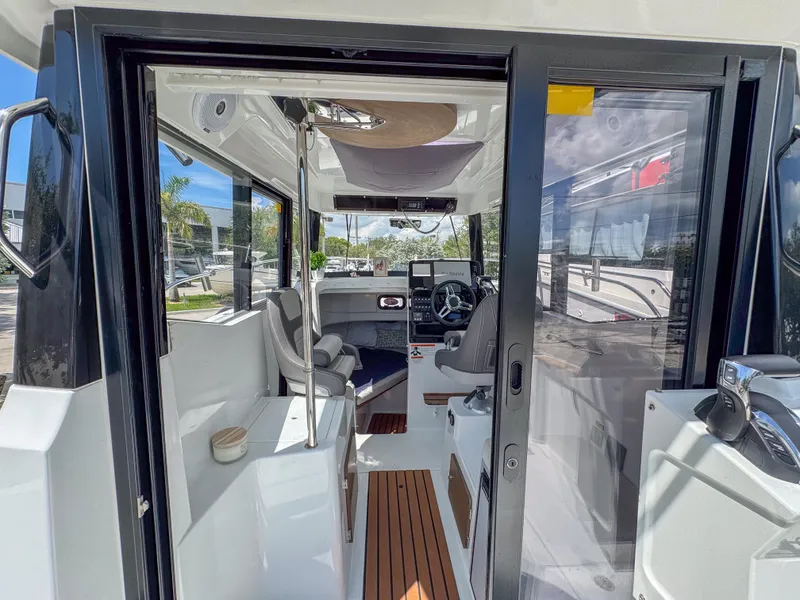 Slide: The Image of 2022 Jeanneau NC795 Sport boat interior with modern helm and seating. - 10