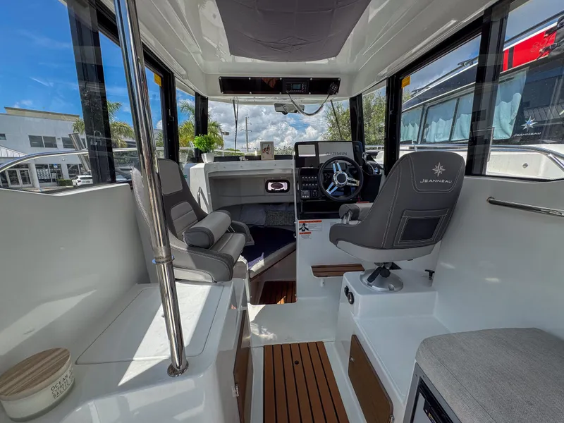 Slide: The Image of Interior of 2022 Jeanneau NC795 Sport boat with modern helm and seating. - 11