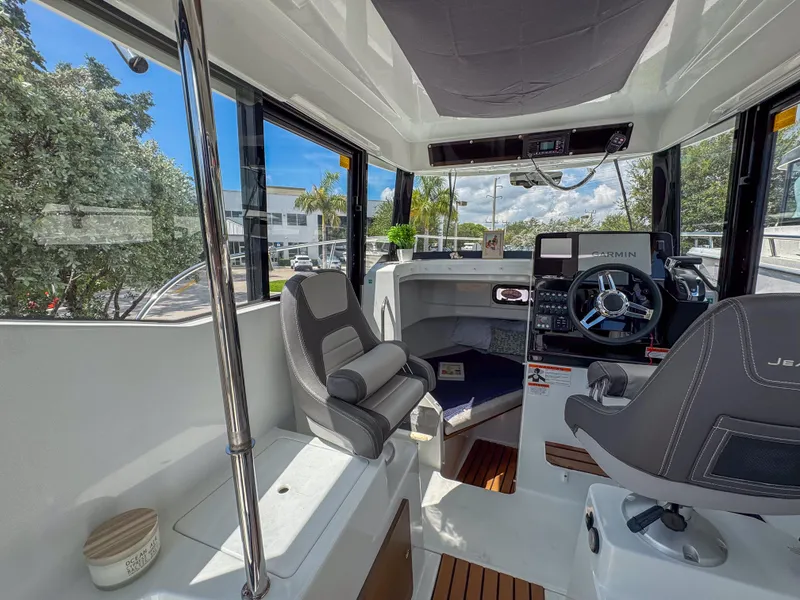 Slide: The Image of Interior of 2022 Jeanneau NC795 Sport boat with modern helm and seating. - 13