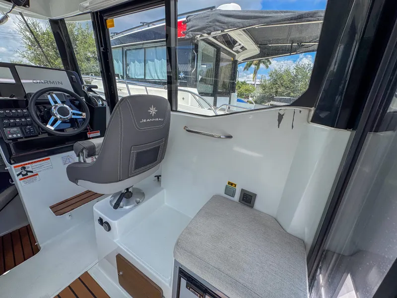 Slide: The Image of Interior of 2022 Jeanneau NC795 Sport boat with steering wheel and seating. - 15