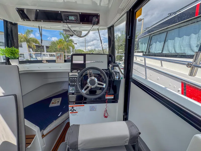 Slide: The Image of Interior of 2022 Jeanneau NC795 Sport boat with steering wheel and navigation equipment. - 17
