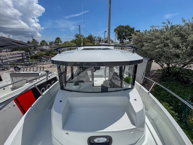 Slide: The Image of 2022 Jeanneau NC795 Sport boat, docked outdoors, showcasing sleek design and modern features. - 28