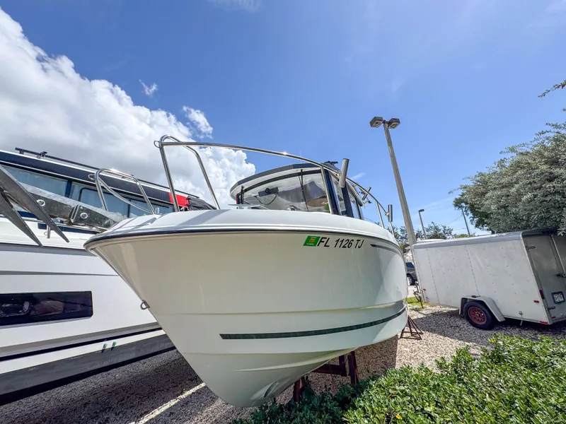 Slide: The Image of 2022 Jeanneau NC795 Sport boat displayed outdoors under a clear blue sky. - 3