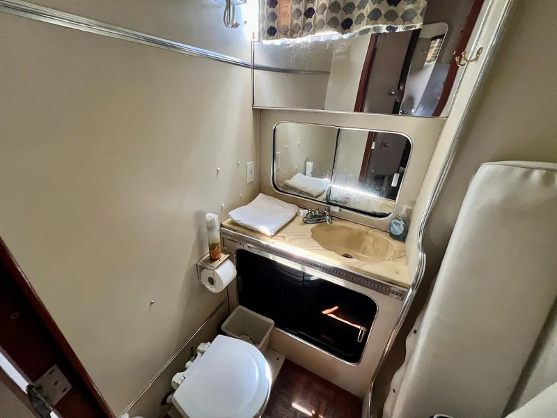 Slide: The Image of 1986 Chris-Craft 381 Catalina bathroom with sink, mirror, and toilet. - 13