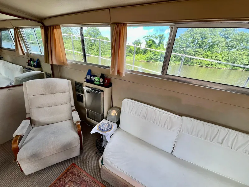 Slide: The Image of Interior of 1986 Chris-Craft 381 Catalina yacht with comfortable seating and scenic window views. - 16