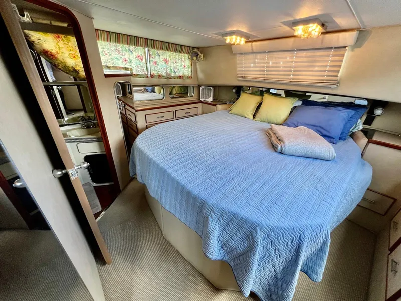Slide: The Image of Interior of 1986 Chris-Craft 381 Catalina with cozy bedroom and blue bedding. - 17
