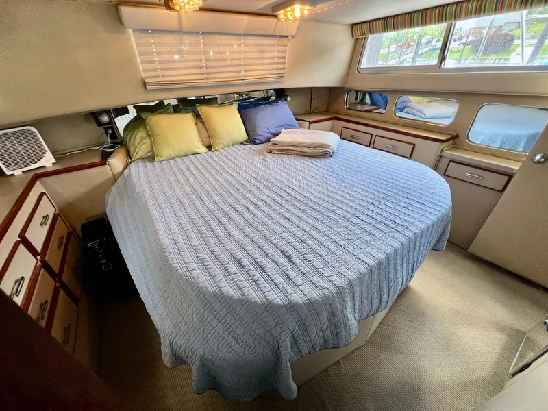 Slide: The Image of 1986 Chris-Craft 381 Catalina cabin with bed, pillows, and windows. - 18