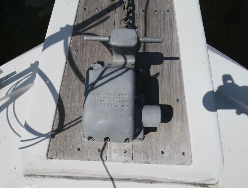 Slide: The Image of 1986 Chris-Craft 381 Catalina anchor windlass on wooden deck, shadow visible. - 19