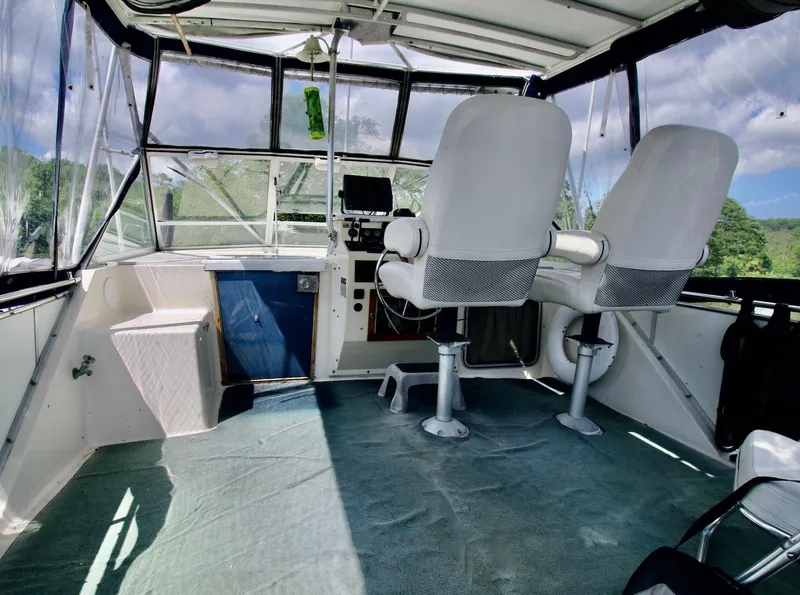 Slide: The Image of Interior of 1986 Chris-Craft 381 Catalina boat with helm and seating area. - 2