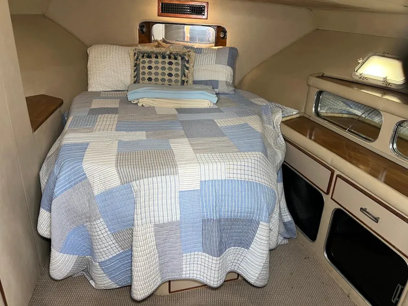 Slide: The Image of 1986 Chris-Craft 381 Catalina cabin with a cozy bed and nautical decor. - 21