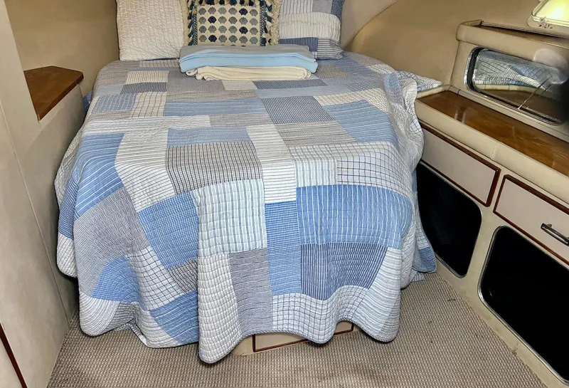 Slide: The Image of Cozy cabin interior of 1986 Chris-Craft 381 Catalina with a patchwork quilted bed. - 22