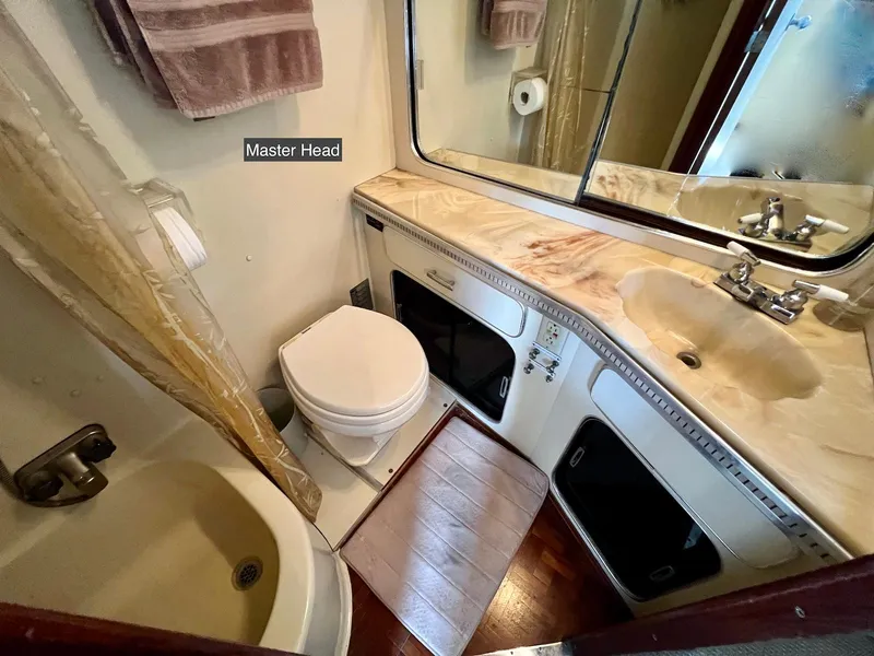 Slide: The Image of 1986 Chris-Craft 381 Catalina master head with sink, toilet, and shower. - 23