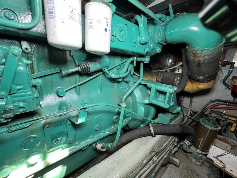Slide: The Image of Engine compartment of 1986 Chris-Craft 381 Catalina, showcasing mechanical components and filters. - 27