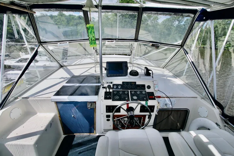 Slide: The Image of 1986 Chris-Craft 381 Catalina helm with modern navigation equipment and comfortable seating. - 3