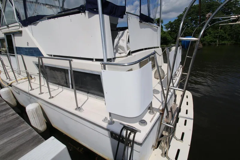 Slide: The Image of 1986 Chris-Craft 381 Catalina docked, showcasing rear deck and railing details. - 4