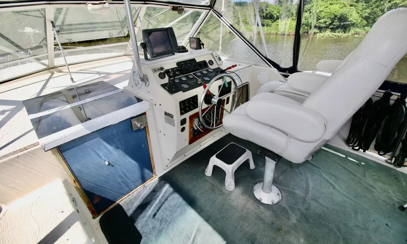 Slide: The Image of 1986 Chris-Craft 381 Catalina helm with white captain's chair and navigation equipment. - 7