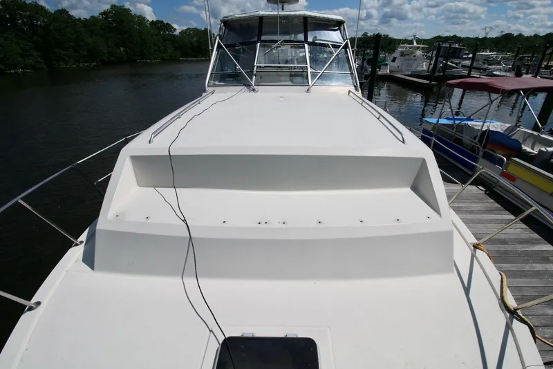 Slide: The Image of 1986 Chris-Craft 381 Catalina yacht docked, showcasing spacious deck and sleek design. - 8