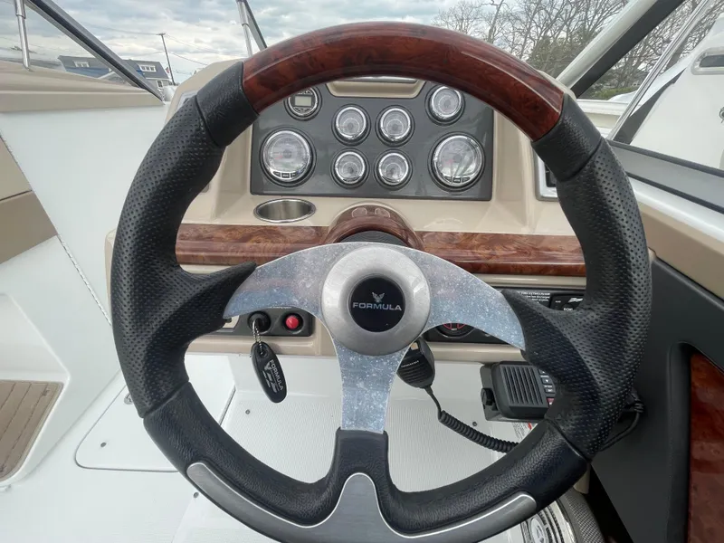 Slide: The Image of Steering wheel and dashboard of a 2012 Formula 270 Bowrider boat. - 15