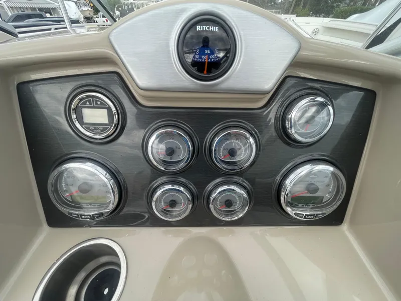 Slide: The Image of Dashboard of a 2012 Formula 270 Bowrider boat with multiple gauges and a compass. - 16