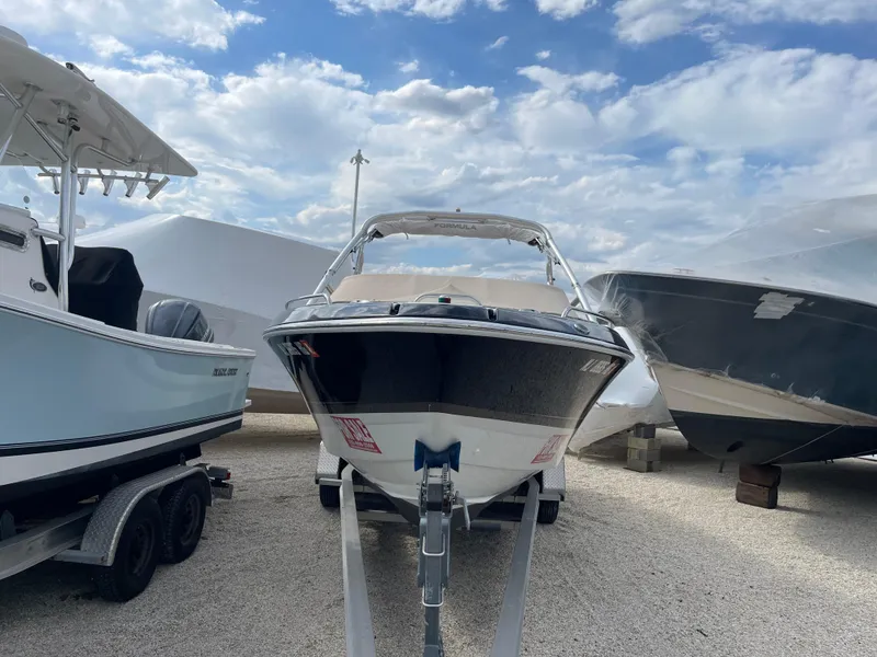 Slide: The Image of 2012 Formula 270 Bowrider boat on display between two other boats. - 2