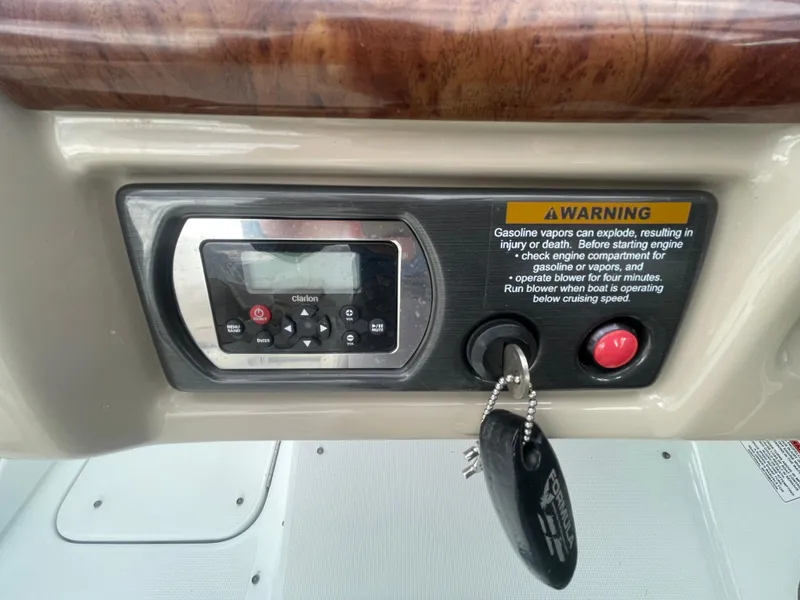 Slide: The Image of Control panel of a 2012 Formula 270 Bowrider boat with warning label and ignition key. - 21