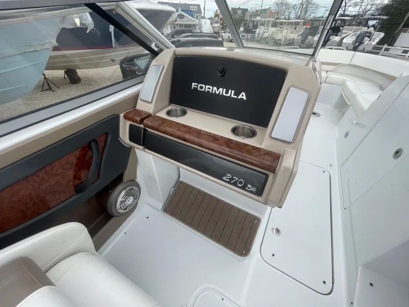 Slide: The Image of 2012 Formula 270 Bowrider interior with cup holders and seating area. - 23