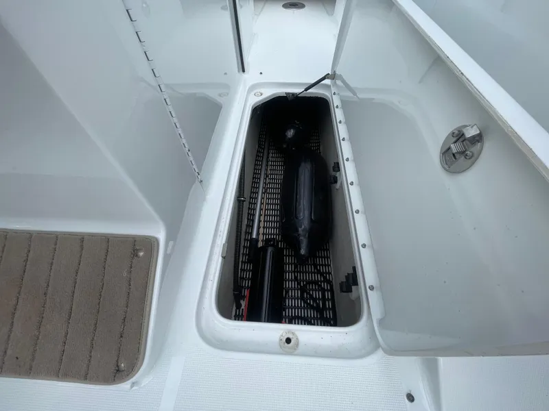 Slide: The Image of 2012 Formula 270 Bowrider storage compartment with open hatch and visible equipment. - 30