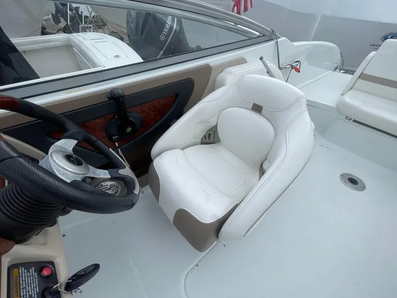 Slide: The Image of 2012 Formula 270 Bowrider cockpit with white seating and steering wheel. - 31