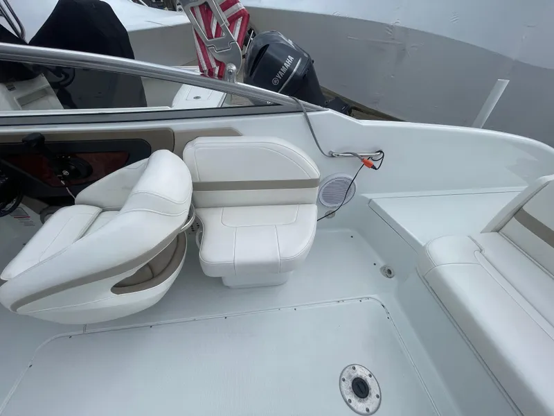 Slide: The Image of 2012 Formula 270 Bowrider interior with white seating and Yamaha engine. - 32