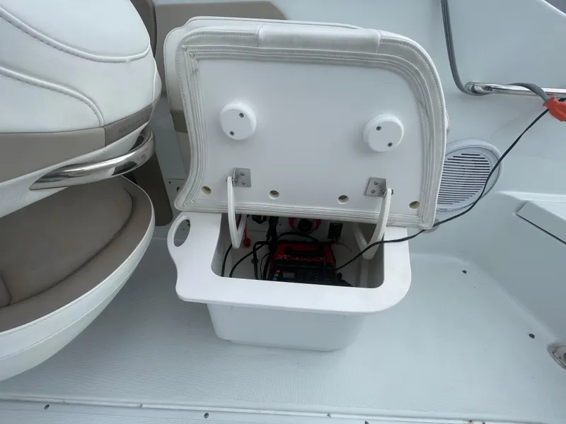 Slide: The Image of 2012 Formula 270 Bowrider boat storage compartment with open lid, revealing interior components. - 33