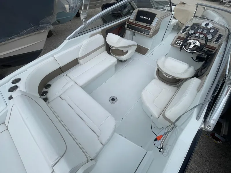 Slide: The Image of 2012 Formula 270 Bowrider boat interior with white seating and modern dashboard. - 38
