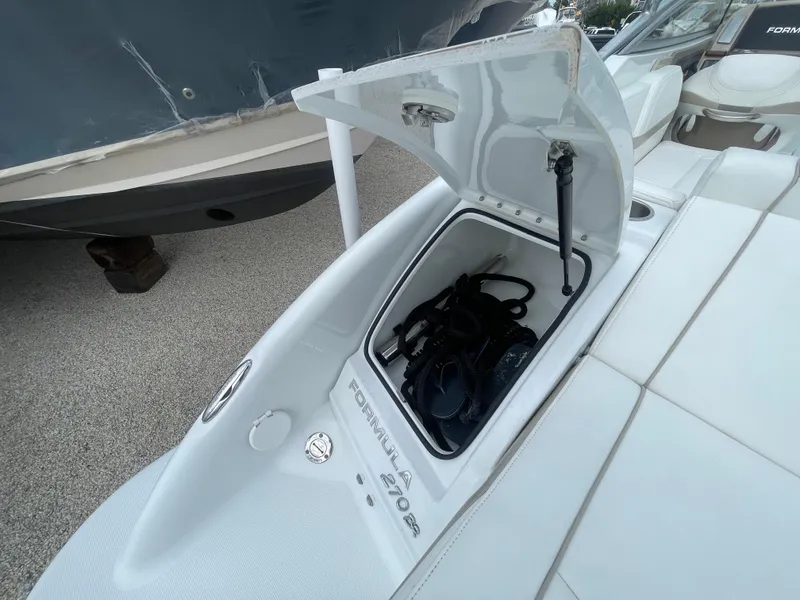 Slide: The Image of 2012 Formula 270 Bowrider boat with open storage compartment on deck. - 41