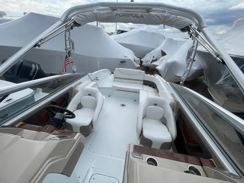 Slide: The Image of 2012 Formula 270 Bowrider boat with white seating and covered storage. - 42