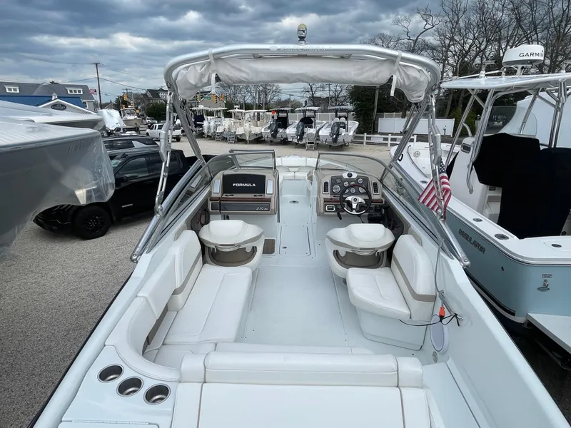 Slide: The Image of 2012 Formula 270 Bowrider boat with spacious seating and sleek design, docked outdoors. - 44