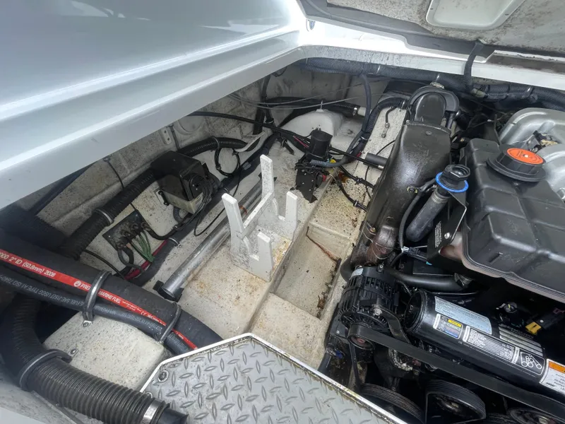 Slide: The Image of Engine compartment of a 2012 Formula 270 Bowrider boat, showcasing mechanical components. - 49