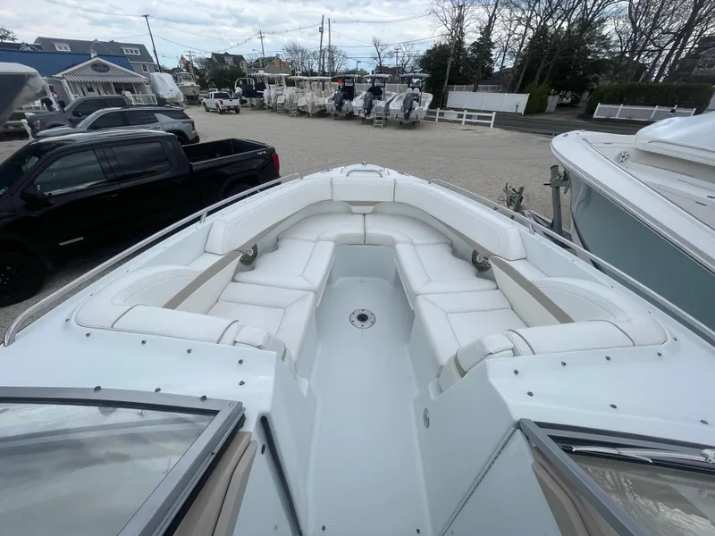 Slide: The Image of 2012 Formula 270 Bowrider with spacious seating, parked in a marina. - 5