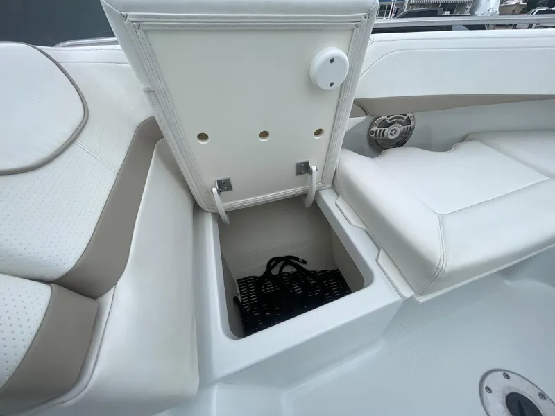 Slide: The Image of 2012 Formula 270 Bowrider boat with open storage compartment and white seating. - 7