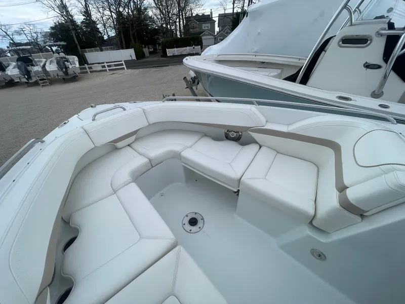 Slide: The Image of 2012 Formula 270 Bowrider with spacious white seating in a marina setting. - 9
