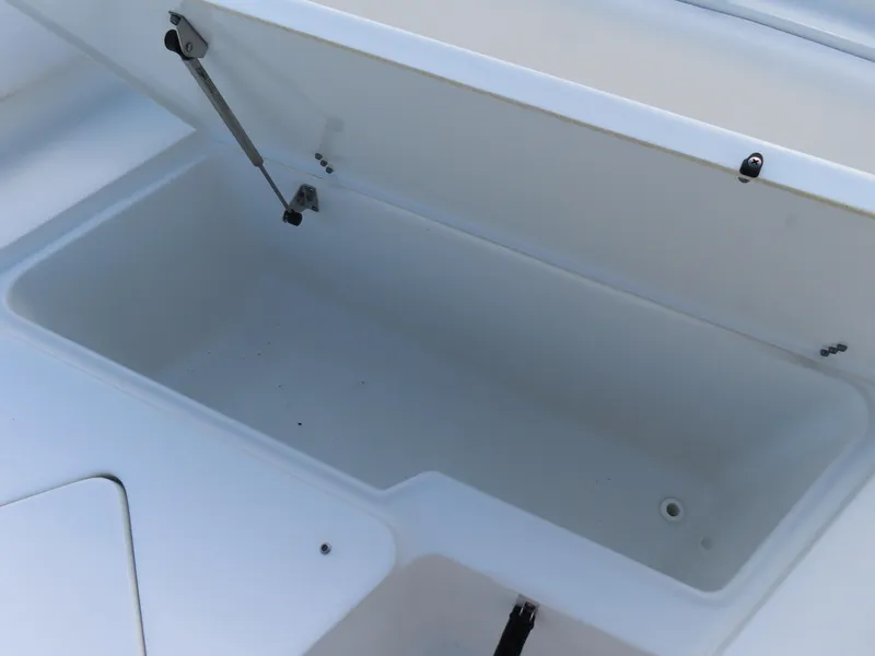 Slide: The Image of Open storage compartment on a 2021 Sea Hunt Ultra 234 boat. - 11