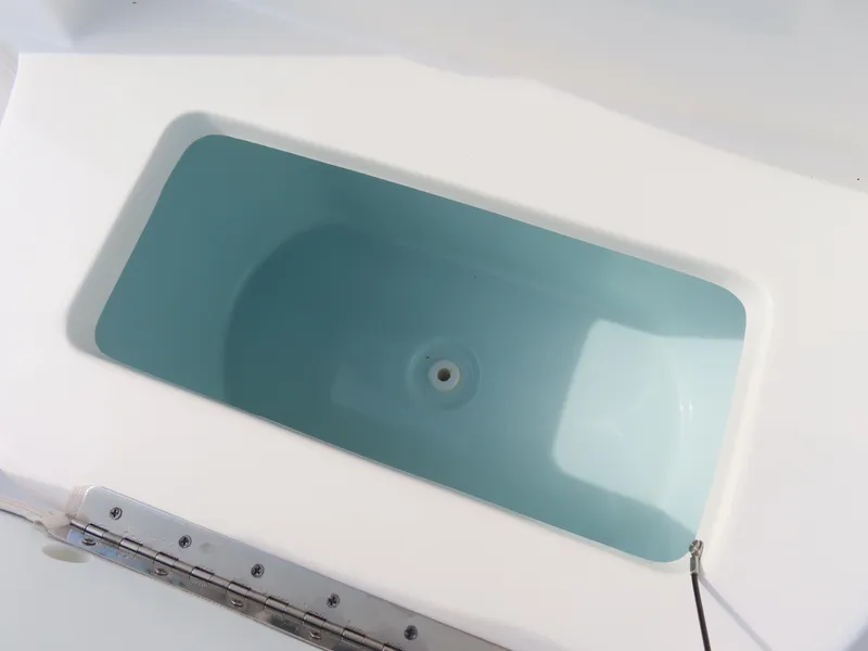 Slide: The Image of Livewell on 2021 Sea Hunt Ultra 234 boat, featuring a clean, white interior design. - 18